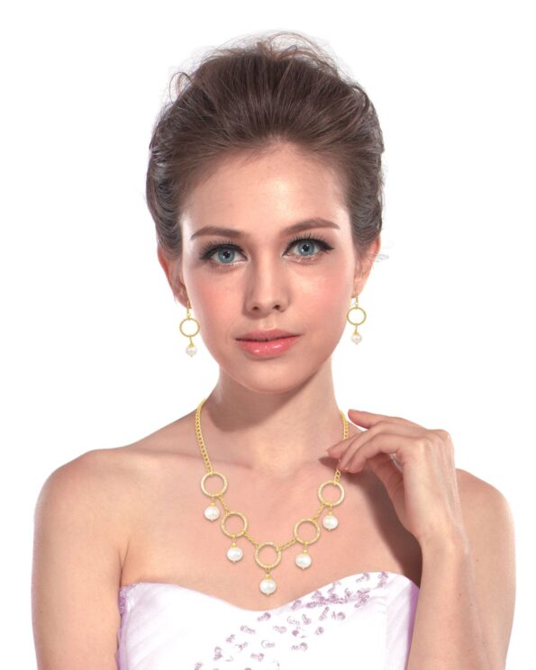 Pearl Necklace Set Designed With Gold Plating In Roundish Shape. It's Uniqueness is That It Have Ring Like Forms In Its Necklace Which Makes It More Beautiful.